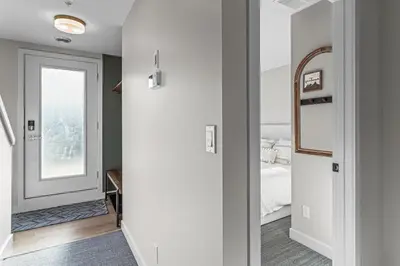 a room with a bedroom with a bed and a mirror at Peak n Plunge Insane MTN View Pool n Hot Tub K201 in Canmore