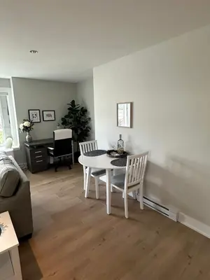 a white table and chairs in a living room at Modern One-Bedroom Retreat in Bear Mountain in Langford