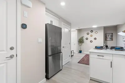 a kitchen with a stainless steel refrigerator in a kitchen at Classic 2 Bed-Basement Near the lake in Edmonton
