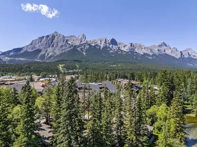 an aerial view of a resort with trees and mountains at 3BR Escape BBQ, Balcony, Near Banff & DT in Canmore