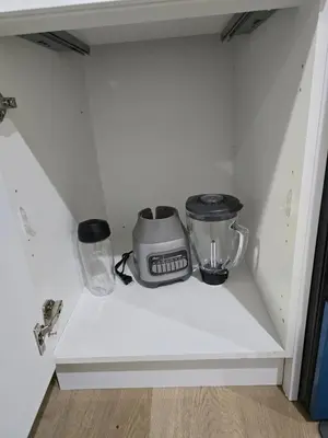 a kitchen shelf with two appliances sitting on it at Lush 1 Bedroom house with WiFi in Edmonton in Edmonton