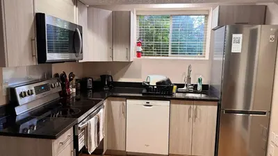 a kitchen with a stove and a refrigerator at Calgary Super Cozy Guest Rooms Near Banff in Calgary