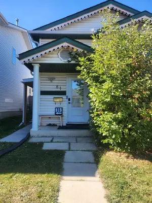 a house with a blue door and a sidewalk at Calgary Super Cozy Guest Rooms Near Banff in Calgary