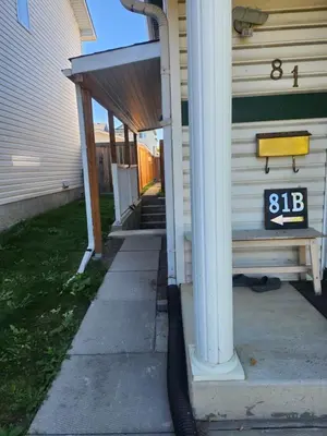 a house with a house number on the side of it at Calgary Super Cozy Guest Rooms Near Banff in Calgary