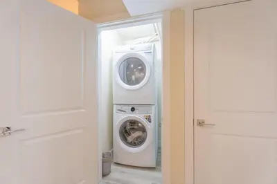 a washing machine and a washer in a room at Anna Suite Rental in Edmonton