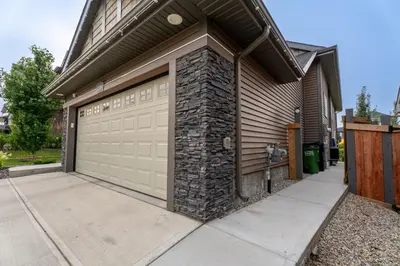 a garage door with a stone wall at Anna Suite Rental in Edmonton
