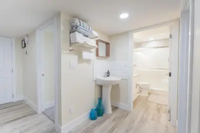 a white bathroom with a sink and a toilet at Anna Suite Rental in Edmonton