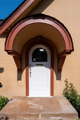 a white garage door with an arch around it at Elegant Spanish Villa with Ocean & Mountain Views in Vancouver