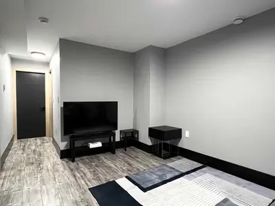 a living room with a flat screen tv on a wall at Spacious 2-Bedroom Retreat in Burnaby in Burnaby