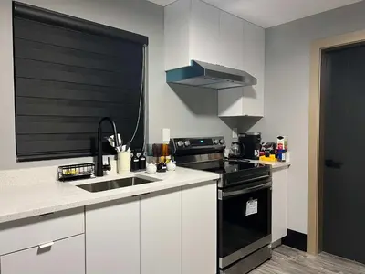 a kitchen with a sink and a stove at Spacious 2-Bedroom Retreat in Burnaby in Burnaby