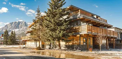 a building with a tree in front of it at Aurora Luxe - Stunning Townhouse Private Hot Tub in Canmore