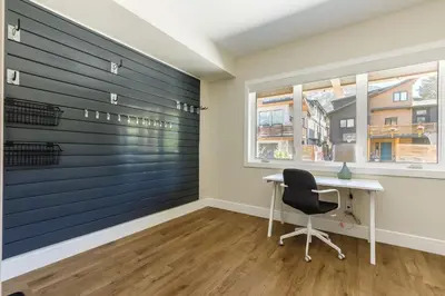 a room with a desk and a window at Aurora Luxe - Stunning Townhouse Private Hot Tub in Canmore