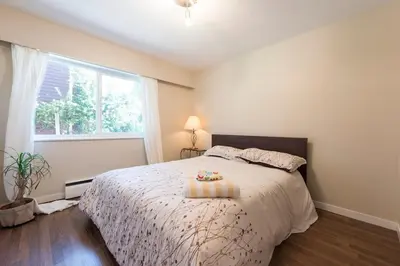 a bedroom with a bed with a cake on it at One Bedroom Suite in perfect location Vancouvers Mount Pleasant in Vancouver
