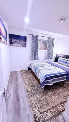 a bedroom with a bed and a rug at Modern Comfort Stay Near Airport in Edmonton
