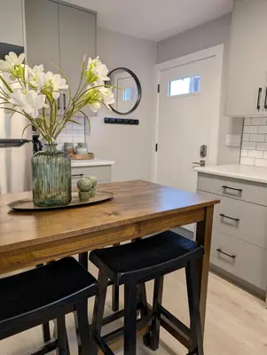 a kitchen with a wooden table with a vase of flowers at Oakview Hideaway in Victoria