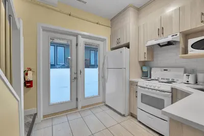 a kitchen with a white refrigerator and a stove at banff woods lodge in Canmore
