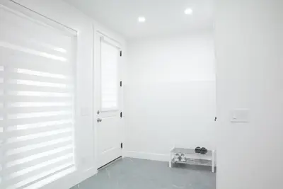 a room with a white wall and a door at 5003R New Luxury Walkout Suite Near Calgary University in Calgary