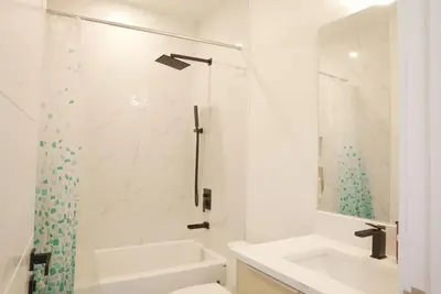 a white bathroom with a shower and a sink at 5003R New Luxury Walkout Suite Near Calgary University in Calgary