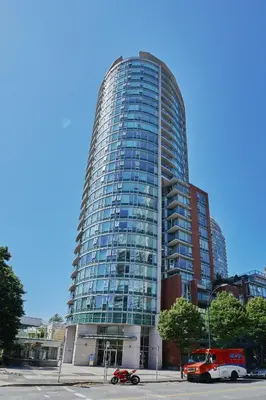 a tall building with a fire truck in front of it at Cozy Urban Living! 2 mins from BC place, private parking ! in Vancouver