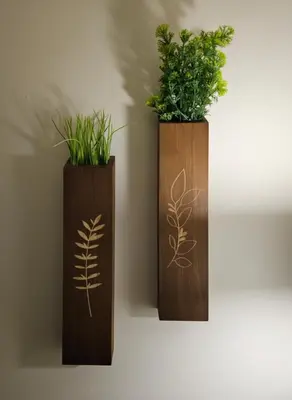 two wooden vases with plants on a wall at Cowichan Valley Retreat with Sauna & Free EV Charger in Duncan