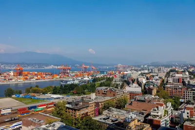 a view of a city with a river and buildings at Spacious 2BD in Vancouver Patio with Ocean View in Vancouver