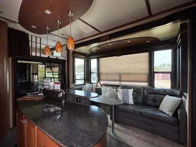 a living room with a couch and a table at Prairie Junction Resort - Furnished RV Apartments in Stettler