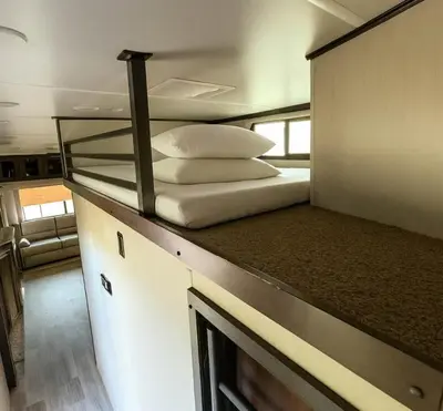 a bedroom with a bunk bed with pillows on a counter at Prairie Junction Resort - Furnished RV Apartments in Stettler