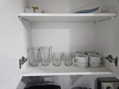a row of glasses on a shelf in a kitchen at Spacious 2 Bedroom Suite in Edmonton in Edmonton