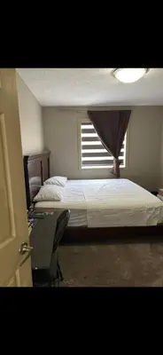 a bedroom with two beds and a window at Coastal Comforts Villa in Airdrie