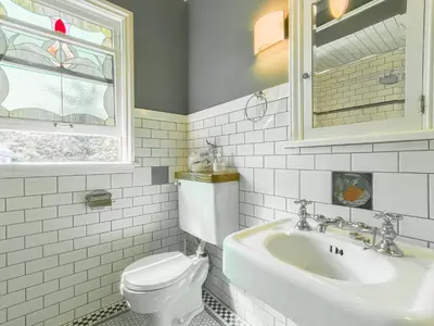 a white bathroom with a toilet and a sink at Cozy Private Bedroom Suite in UBC Campus in Vancouver