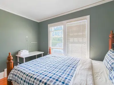 a bedroom with a bed and a window at Cozy Private Bedroom Suite in UBC Campus in Vancouver