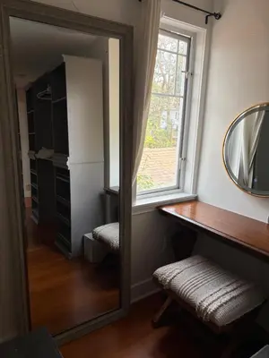 a mirror in a room with a window and a table at Charming Victoria Character Home-Pet Friendly in Victoria