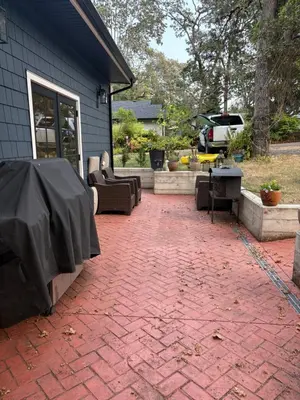 a brick patio with couches and a table in front of a house at Charming Victoria Character Home-Pet Friendly in Victoria
