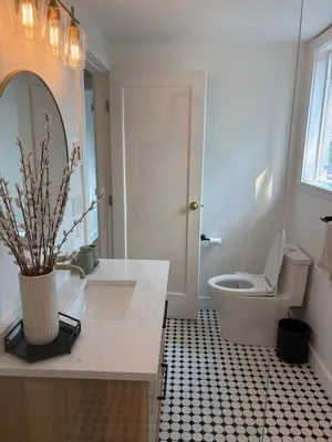 a bathroom with a white sink and a toilet at Charming Victoria Character Home-Pet Friendly in Victoria