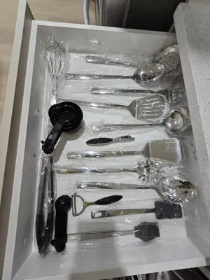 a box with a bunch of utensils in it at Cozy Modern Spacious 2 Bedroom and full kitchen in Southwest Calgary in Calgary