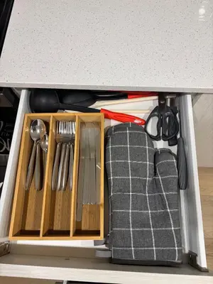 a cabinet with a couch under a counter with utensils at Chezeey Home in Edmonton