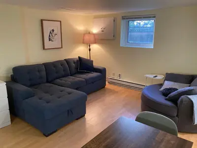 a living room with a couch and a couches and a table at Private Suite in Vancouver in Vancouver