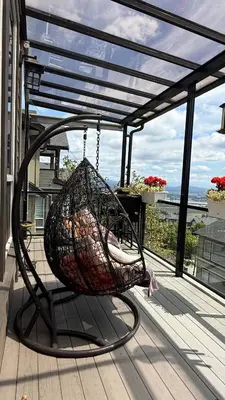 a basket swing on a porch with a view at Carrie's The Gentle Nest No 2 in Coquitlam