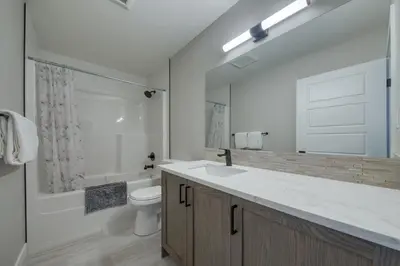 a bathroom with a sink and a toilet and a shower at Stunning NEW 3 Bedroom Mountain View Condo in Radium Hot Springs