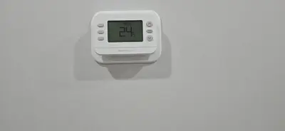 an alarm clock is hanging on a wall at Glacier Comfort Living Suite in Calgary