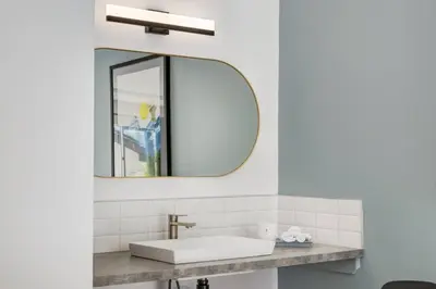 a bathroom with a sink and a mirror at Gateway Suites Single Private Room Near Banff and Canmore in Canmore