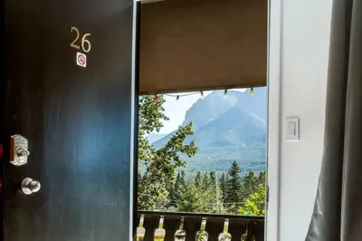 a door with a window with a view of a mountain at Gateway Suites Private Double room near Banff in Canmore