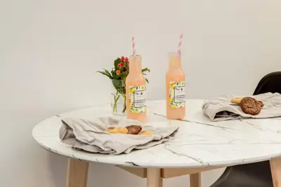 a white marble table with two bottles of soda at Gateway Suites Rocky Mountains Private Double room close to Banff in Canmore