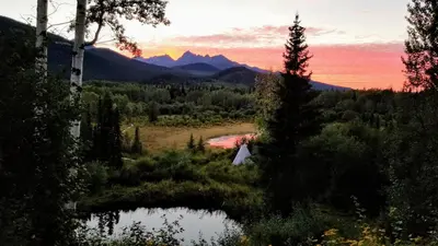 a view of a lake with mountains in the background at Country Rustic Loghouse at Teepee Meadows in Valemount