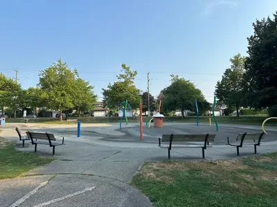 a group of benches in a park with a playground at Cozy Dreamscape in Surrey