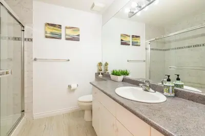 a bathroom with a sink and a toilet and a shower at Adorable, 2 Bedrooms in West Vancouver in West Vancouver