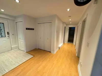an empty living room with wood floors and white walls at Adorable, 2 Bedrooms in West Vancouver in West Vancouver