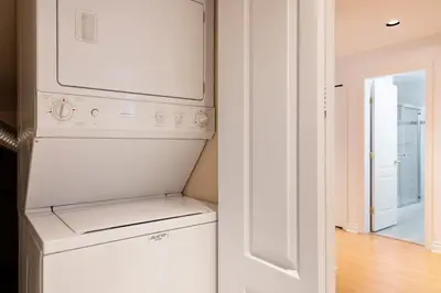 a white washer and dryer in a white kitchen at Adorable, 2 Bedrooms in West Vancouver in West Vancouver