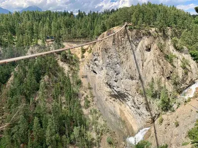 a train on a bridge over a mountain at Chancellor Peak 1BR and Loft Wooden Cabin near Lake Louise in Golden