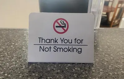 a sign that says thank you for not smoking on a counter at A beautiful 2 bedroom private home in Hinton